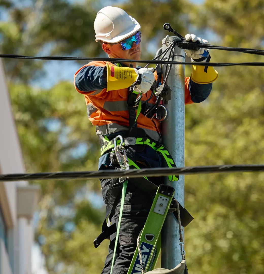Electrician Working on Top of Electric Pole